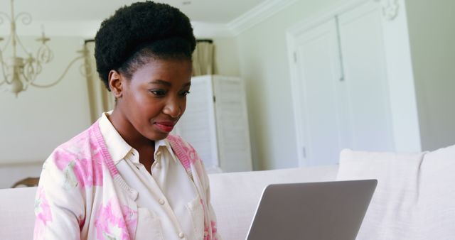 Woman Smiling Wearing Pink Floral Blouse Using Laptop at Home - Download Free Stock Images Pikwizard.com