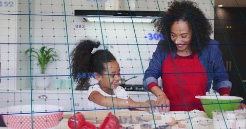 Mother guiding daughter smiling while rolling dough in bright kitchen, teaching baking and bonding