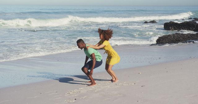 Couple Playing Piggyback Ride on Sunny Beach - Download Free Stock Images Pikwizard.com