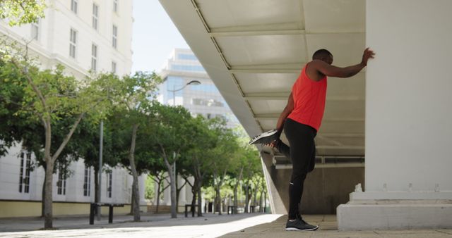 Athlete stretching leg preparing for outdoor workout in urban setting - Download Free Stock Images Pikwizard.com