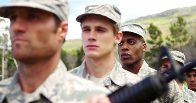 Soldiers wearing military uniforms stand in disciplined formation outdoors, demonstrating readiness and focus. Perfect for topics on military pride, discipline, teamwork, and service. Suitable for use in articles, blogs, or advertisements related to military affairs, defense services, and patriotic themes.