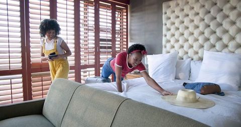 Couple Packing for Vacation with Open Suitcase and Passports