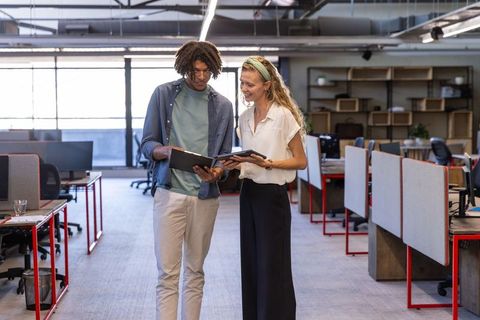 Diverse colleagues discussing data in modern coworking space