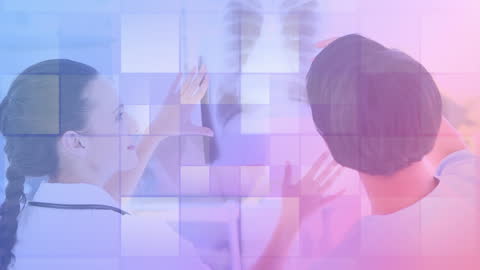 Medical Professionals Analyzing X-ray with Digital Display