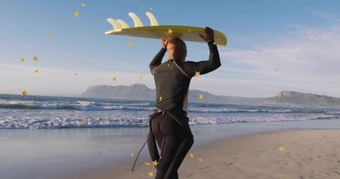 Surfer Holding Yellow Board with Ocean Backdrop