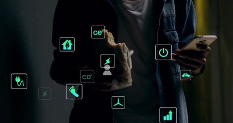 Man checking smartphone while holding sandwich with ar sustainability icons