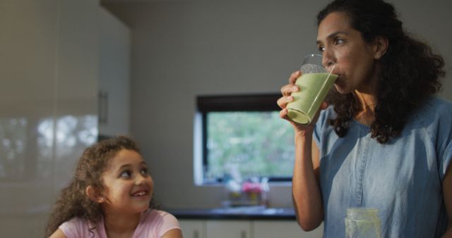 Mother and Daughter in Kitchen Drinking Healthy Green Smoothies - Download Free Stock Images Pikwizard.com