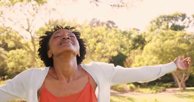 Joyful Woman Savoring Nature with Open Arms in Sunny Park - Download Free Stock Images Pikwizard.com