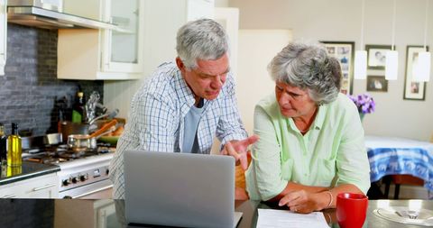 Senior Couple Collaborating on Laptop in Modern Kitchen - Download Free Stock Images Pikwizard.com