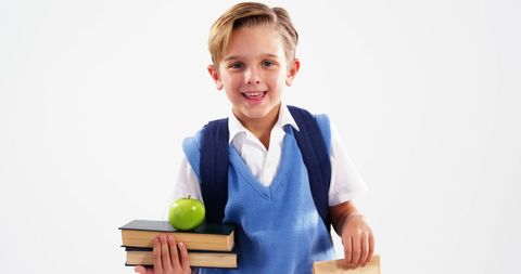 Happy Schoolboy Holding Books and Apple Ready for School - Download Free Stock Images Pikwizard.com