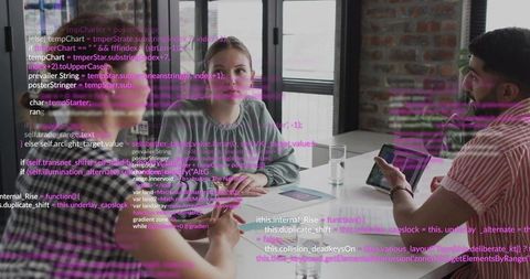 Woman Listening During Team Meeting While Presenter Shows Code on Tablet in Modern Office