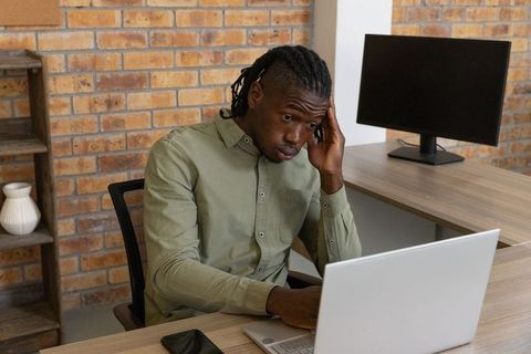 Business Professional Concentrating in Modern Office Setting