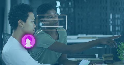 Colleagues Collaborating at Office Desk with Digital Icons