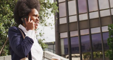 Businesswoman Talking on Phone Outdoors in Urban Setting