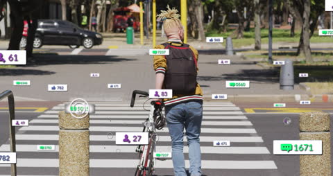 Man Pushing Bicycle Across Street Boots with Social Media Notifications