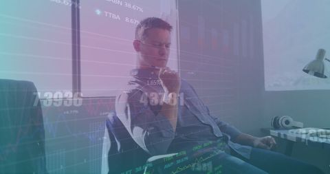 Businessman analyzing market trends with digital graphics overlay