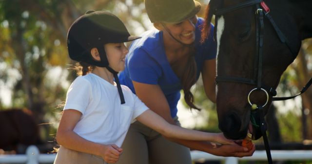 Smiling Instructor Helping Young Girl Feed Horse - Download Free Stock Images Pikwizard.com