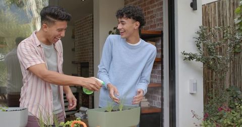 Diverse Male Friends Engaged in Gardening on Patio