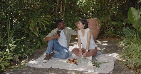 Romantic Couple Enjoying Picnic Together in Serene Garden