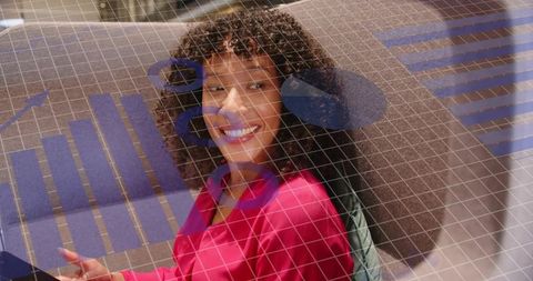 Smiling professional woman using tablet with digital data graphics overlay