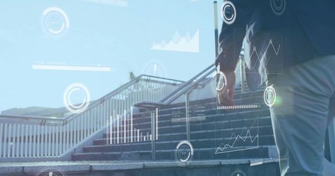 Asian businessman climbing urban stairs carrying briefcase with digital analytics overlay