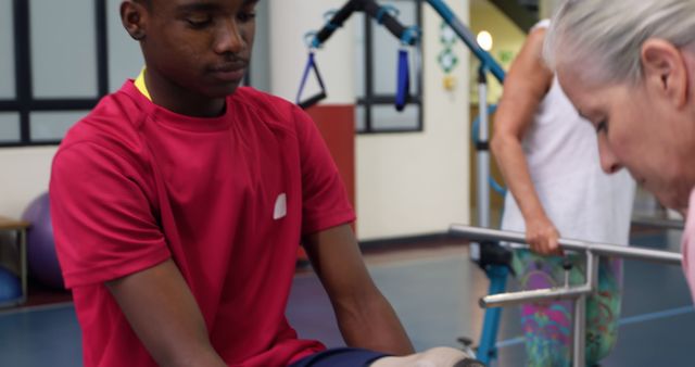 Physical therapy session with young man and therapist assisting exercises - Download Free Stock Images Pikwizard.com