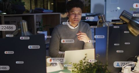 Man Analyzing Social Media Data Notifications on Laptop
