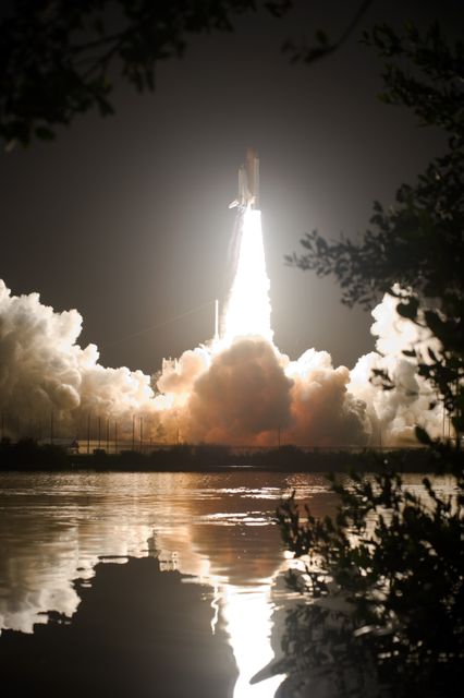 CAPE CANAVERAL, Fla. – Racing to space atop a tower of flame, space shuttle Discovery lights the night sky at liftoff, all captured in the water near Launch Pad 39A at NASA's Kennedy Space Center in Florida.  Liftoff from Launch Pad 39A on the STS-128 mission was on time at 11:59 p.m. EDT. The first launch attempt on Aug. 24 was postponed due to unfavorable weather conditions.  The second attempt on Aug. 25 also was postponed due to an issue with a valve in space shuttle Discovery's main propulsion system.  The STS-128 mission is the 30th International Space Station assembly flight and the 128th space shuttle flight. The 13-day mission will deliver more than 7 tons of supplies, science racks and equipment, as well as additional environmental hardware to sustain six crew members on the International Space Station. The equipment includes a freezer to store research samples, a new sleeping compartment and the COLBERT treadmill.  Photo credit: NASA/Tony Gray-Tom Farrar