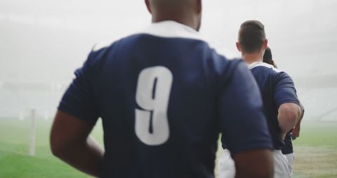 Athletic Men in Soccer Jerseys on a Foggy Sports Field