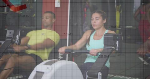 Focused woman rowing on ergometer during group cardio training with digital data overlay