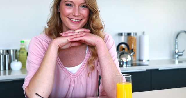 Smiling Woman Enjoying Breakfast with Orange Juice in Modern Kitchen - Download Free Stock Images Pikwizard.com