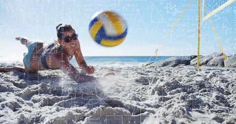 Athlete Diving for Volleyball on Sandy Beach Under Blue Sky