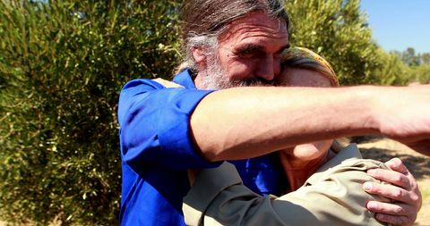 Middle-Aged Man Embraces Loved One Outdoors - Download Free Stock Images Pikwizard.com