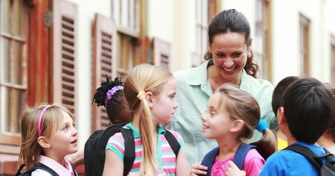 Caring Teacher Engaging with Young Students Outdoors - Download Free Stock Images Pikwizard.com