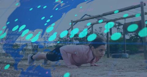 Determined woman doing push-ups on adventure course