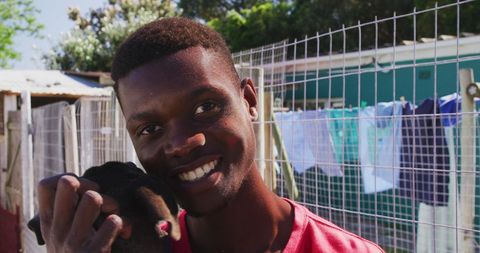Smiling volunteer with rescued dog at animal shelter