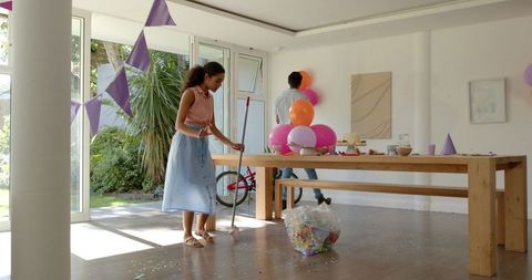 Family Cleaning Confetti After Birthday Party at Home