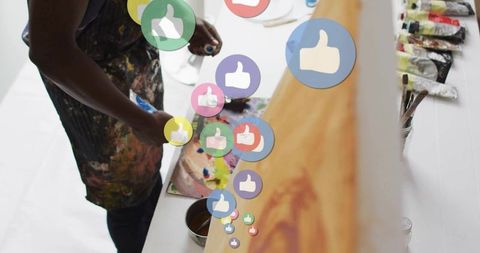 Artist in Studio Engaging with Social Media Likes on Palette