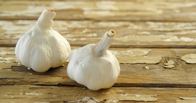 Rustic Garlic Bulbs Resting on Aged Wooden Table - Download Free Stock Images Pikwizard.com