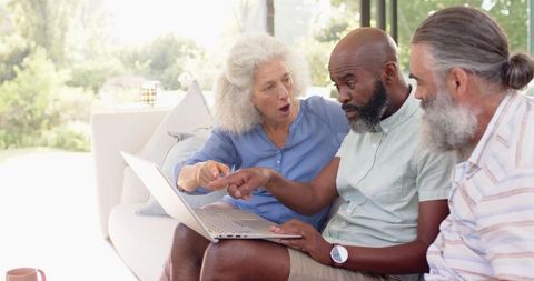 Senior Friends Discussing Surprising Content on Laptop - Download Free Stock Images Pikwizard.com