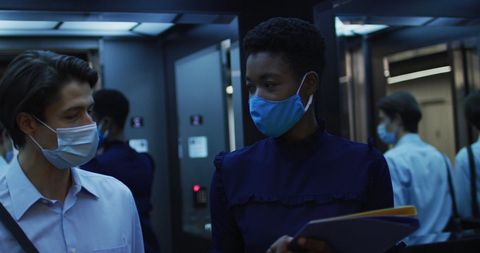 Business Professionals Cooperating With Safety Masks in Office Setting