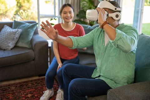 Asian Couple Experiencing Virtual Reality at Home