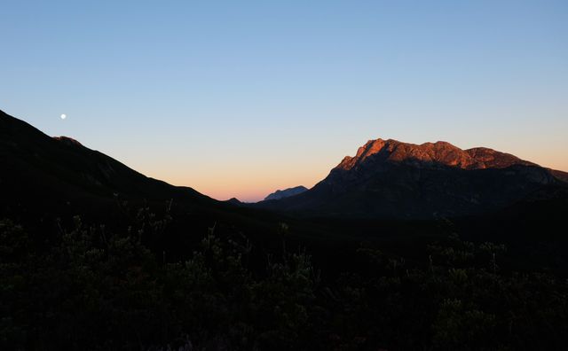Sunset Over Mountain Range with Moon in Sky - Download Free Stock Photos Pikwizard.com