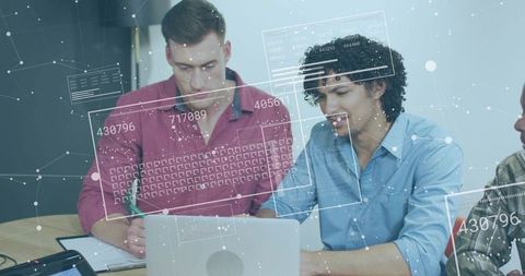 Young Professionals Collaborating on Data with Augmented Reality Dashboard and Laptop