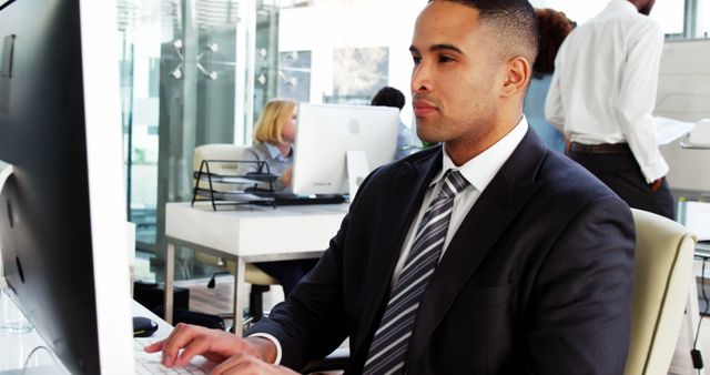 Confident Businessman Working on Computer in Modern Office - Download Free Stock Photos Pikwizard.com