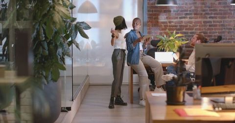 Collaborative Office Meeting With Enthusiastic Colleagues Discussing Project