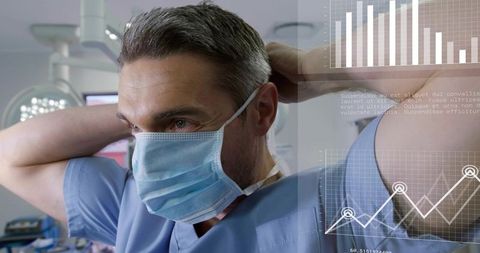 Experienced surgeon adjusting surgical mask in operating room with medical data overlays