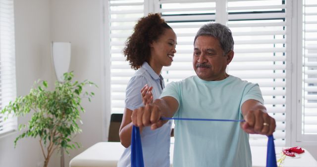 Senior Man Exercising with Resistance Band with Support of a Female Physical Therapist - Download Free Stock Images Pikwizard.com