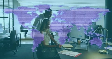 Manager guiding analyst at laptop with purple holographic world map visualizing global data