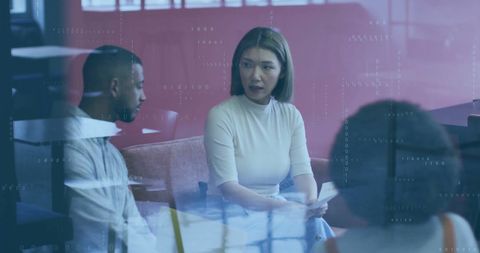 Diverse Team Discussing Strategy with Digital Interface Overlay